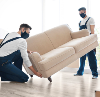 Two men moving couch for interior design studio