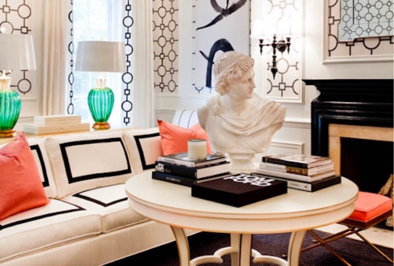 Table with decor pieces and antique statue in eclectically designed sitting room